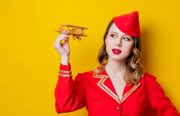 istock charming vintage stewardess wearing in red uniform with airplane 1128777283