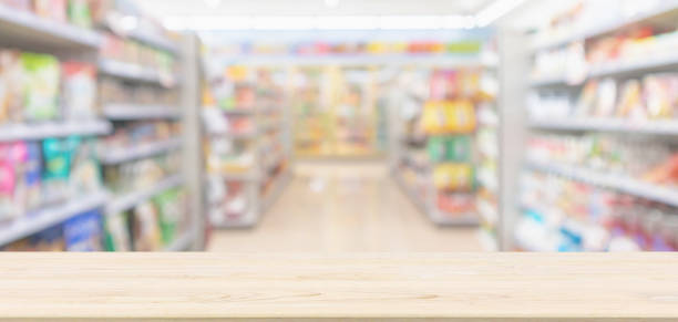 istock Empty Wood table top with supermarket grocery store blurred defocused background with bokeh light for montage product display 1128781189