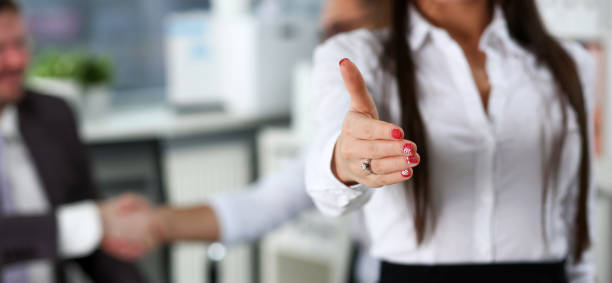 istock Woman in suit give hand as hello in office 1128781400