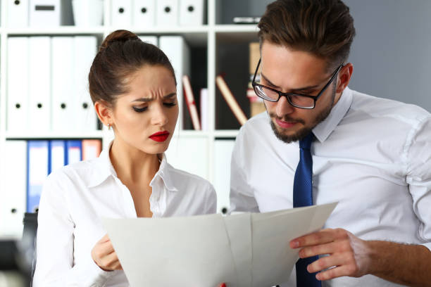 istock Group of modern businesspeople in office debate on financial issue 1128781437