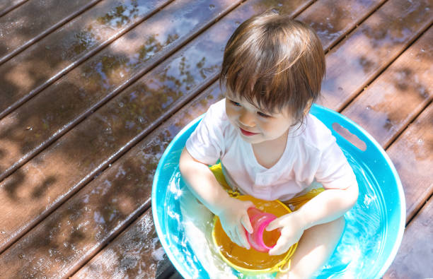 istock Young toddler boy playing with water 1128781695