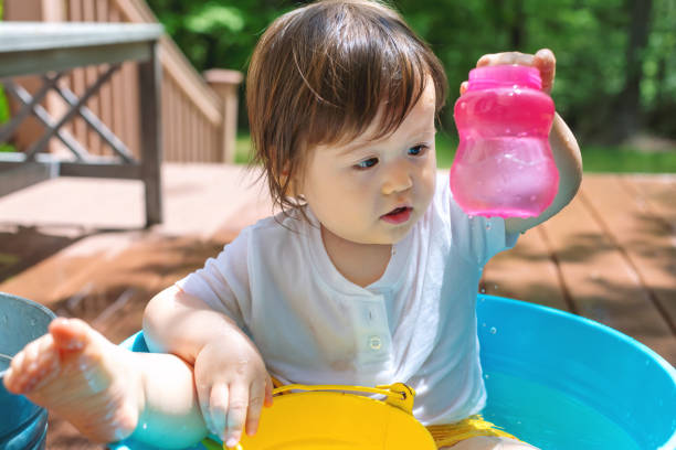 istock Young toddler boy playing with water 1128781701