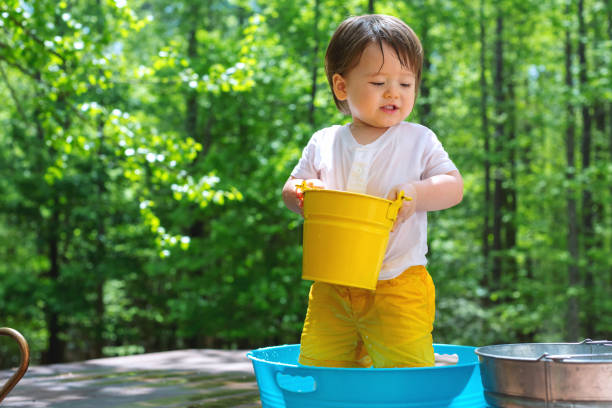 istock Young toddler boy playing with water 1128781709
