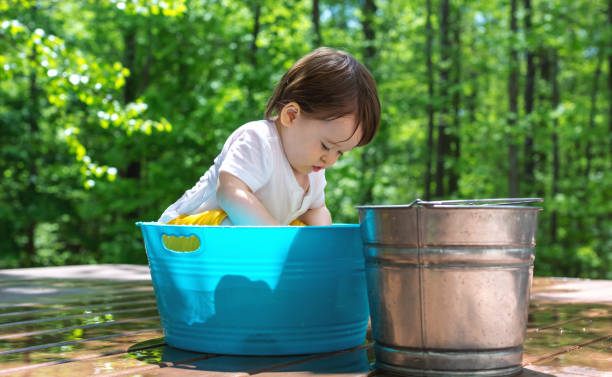 istock Young toddler boy playing with water 1128781767