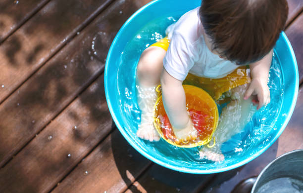 istock Young toddler boy playing with water 1128782207