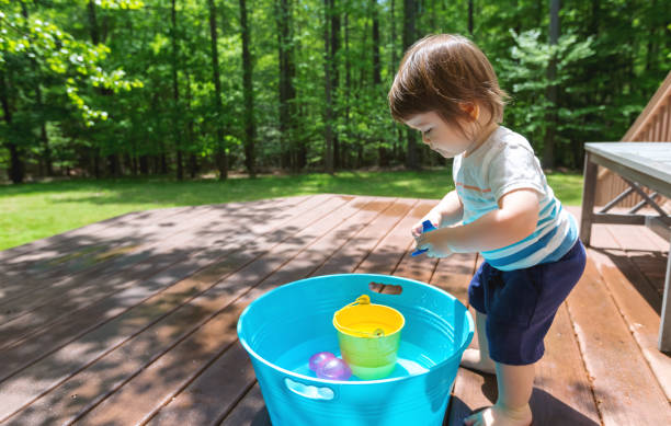 istock Young toddler boy playing with water 1128782215