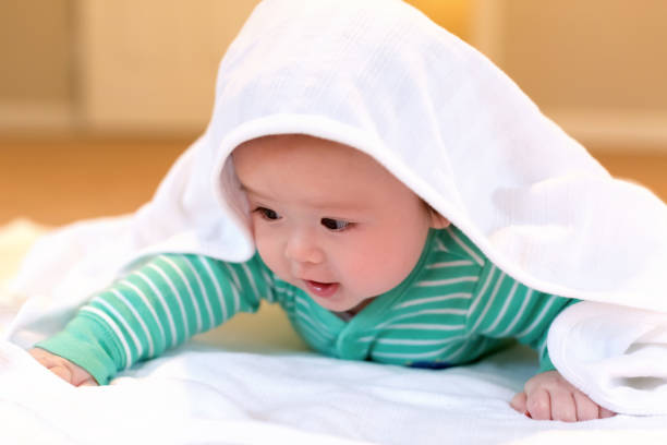 istock Baby boy playing with a blanket 1128782257
