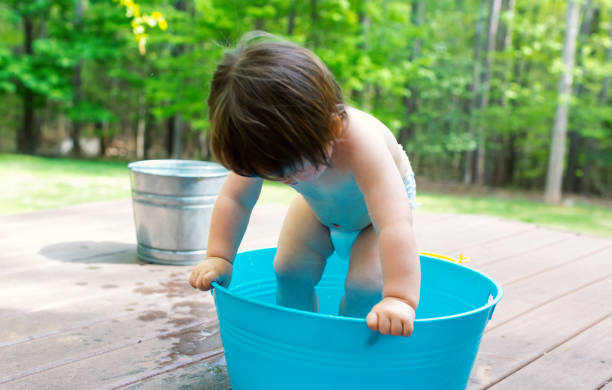 istock Toddler boy playing in a little bath tub 1128782280