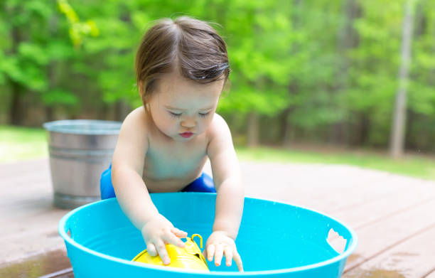 istock Toddler boy playing in a little bath tub 1128782298