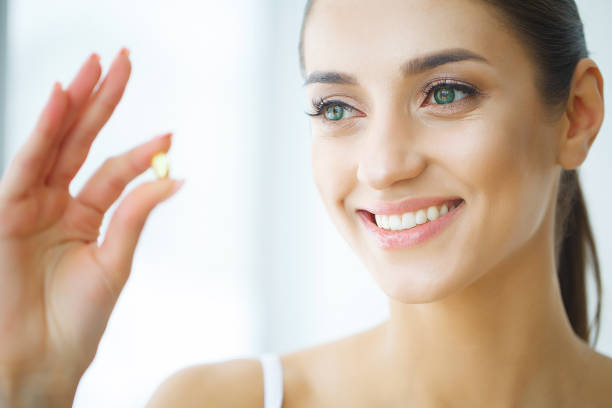istock Beautiful Woman Taking Pill, Medicine. Vitamins And Supplements 1128783451