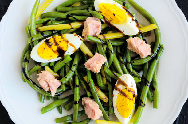 istock Warm salad with cooked green beans, tuna and boiled eggs 1128783981