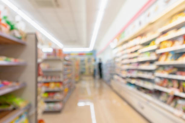 istock Supermarket aisle interior shelves blur background 1128783994
