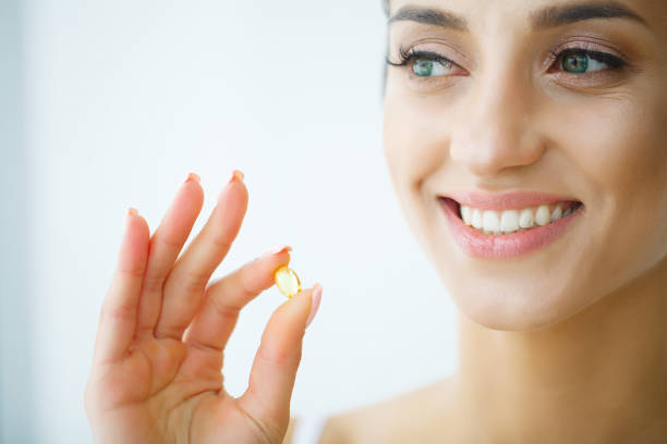istock Beautiful Woman Taking Pill, Medicine. Vitamins And Supplements 1128784132