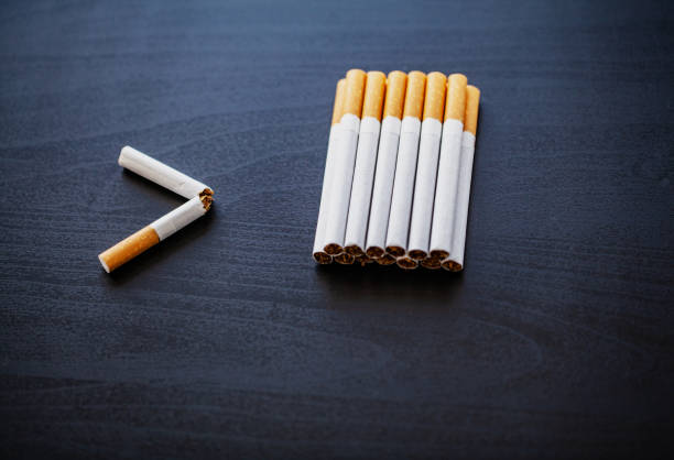 istock Stop smoking concept on background with broken cigarettes. Heap of cigarettes. No smoking 1128785508