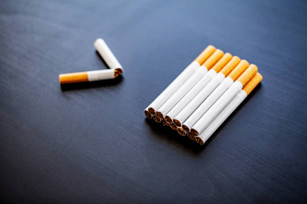 istock Stop smoking concept on background with broken cigarettes. Heap of cigarettes. No smoking 1128786165