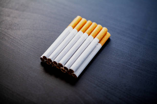 istock Stop smoking concept on background with broken cigarettes. Heap of cigarettes. No smoking 1128786569