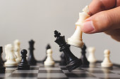 istock Plan leading strategy of successful business competition leader concept, Hand of player chess board game putting white pawn, Copy space for your text 1128789429