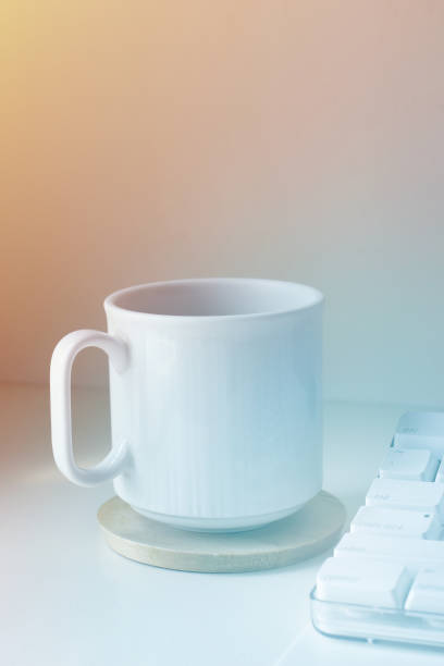 istock Cup of Coffee on Desk next to Computer 1128793277