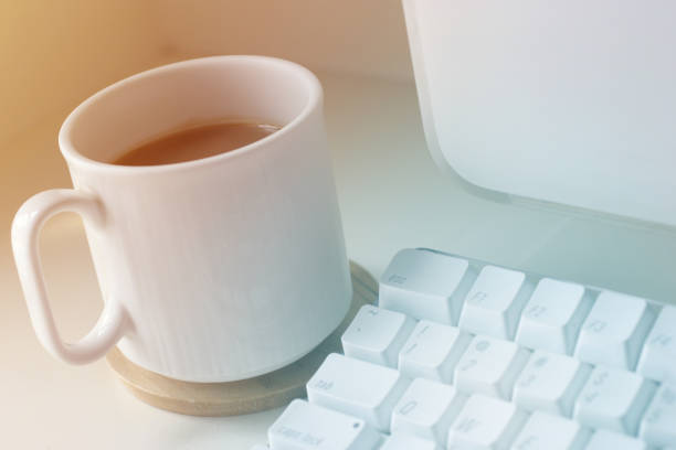 istock Cup of Coffee on Desk next to Computer 1128793282