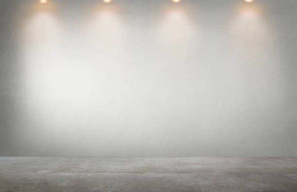 Gray wall with a row of spotlights in an empty room Gray wall with a row of spotlights in an empty room empty office stock pictures, royalty-free photos & images