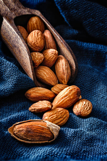 Close-up of open Almonds in a group coming out from a serving scoop stock photo