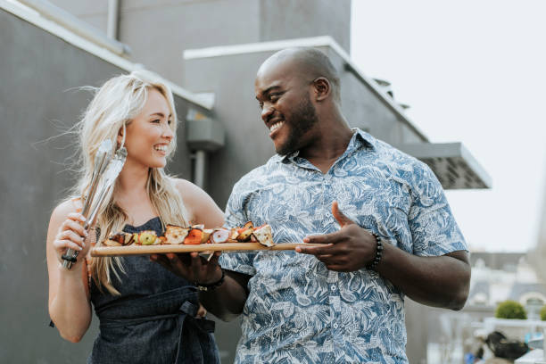 istock Happy couple preparing barbeque skewers 1128796498