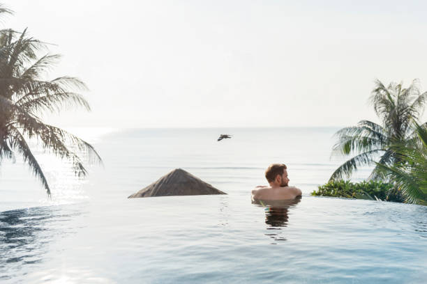 istock Handsome guy relaxing in swimming pool 1128796620