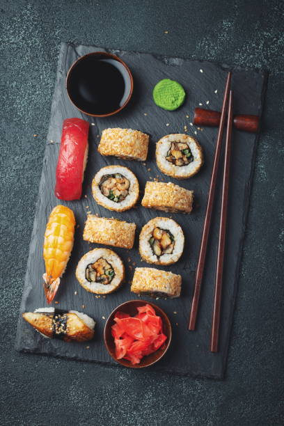 istock Set of sushi and maki on stone table. 1128808384