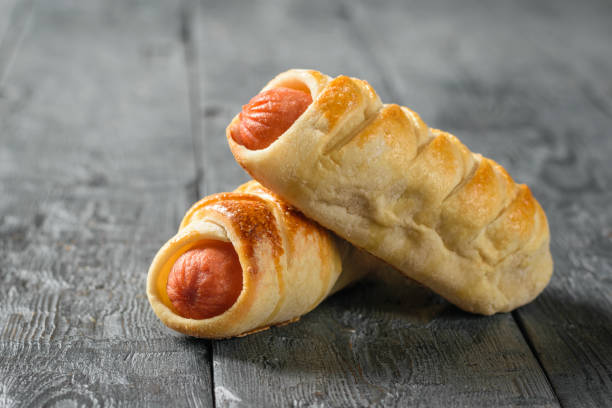 istock Two homemade sausages on a wooden table. 1128811016