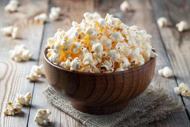 istock A wooden bowl of salted popcorn on rustic table. 1128812222