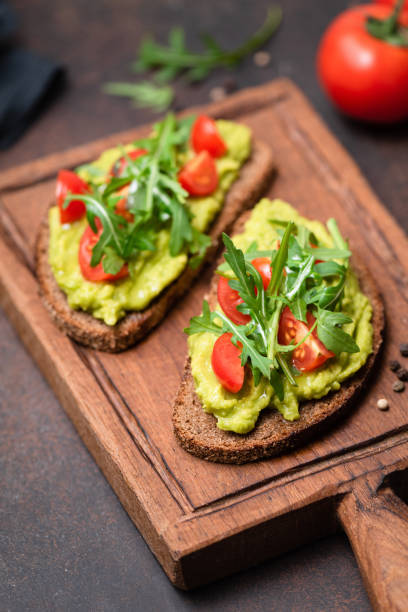 istock Healthy toast with avocado, tomato, arugula 1128813365