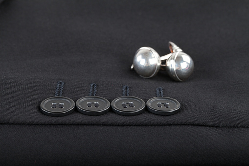 Close up picture of mens suit sleeve and silver cufflinks