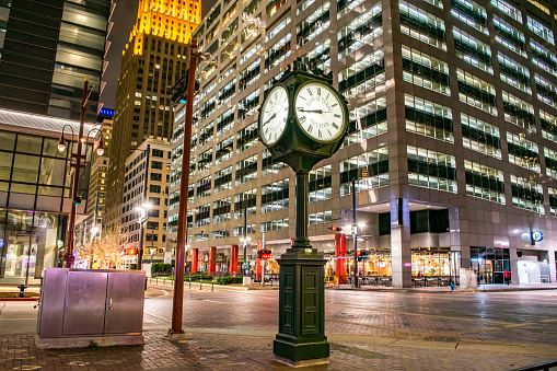 Historic Clock at street intersection (Main and Texas) in downtown Houston, Texas, at night.