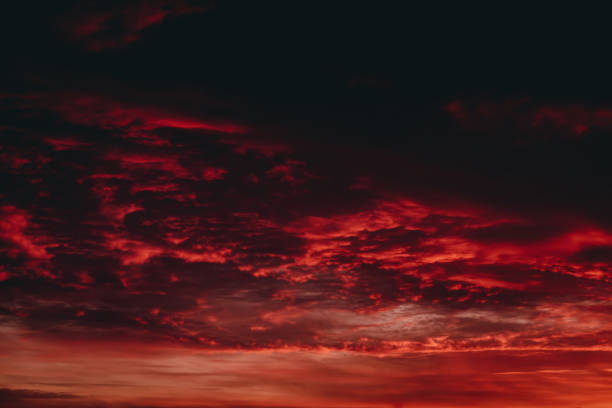 istock Fiery red blood vampire dawn. Amazing warm dramatic fire cloudy sky. Vivid orange sunlight. Atmospheric background of sunrise in overcast weather. Hard cloudiness. Storm clouds warning. Copy space. 1128817277