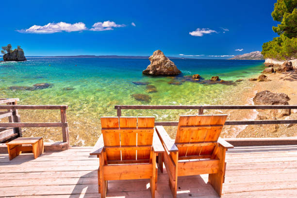 relax deck chair by idyllic adriatic beach - beach palm tree island deck chair imagens e fotografias de stock