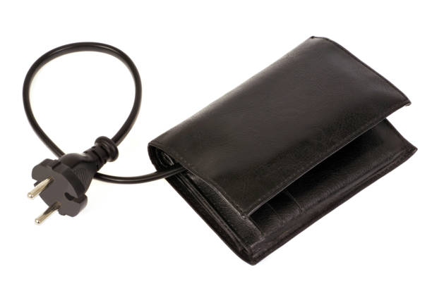 Energy expenditure concept of electricity expenses with a wallet connected to a power supply cable dépense stock pictures, royalty-free photos & images