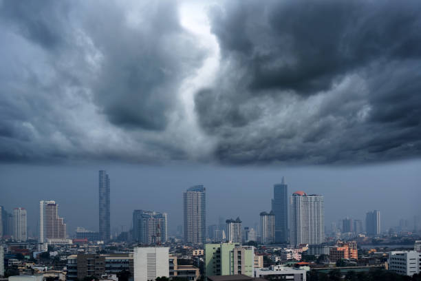 istock Incoming storm clouds over building in town before heavy rain falling in Asia 1128821770
