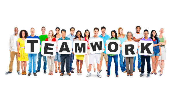 istock Multi-Ethnic Group Of Diverse People Holding Letters That Form Teamwork 1128822117