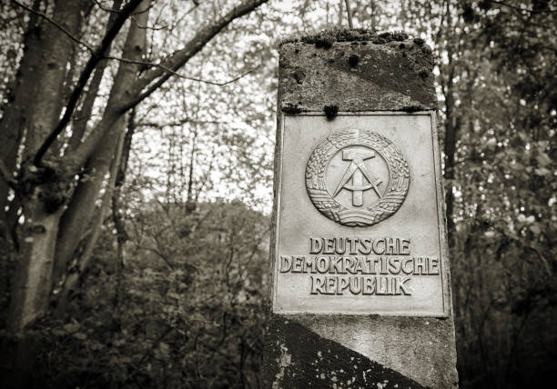 Braunlage, Germany - April 29, 2018: Border pillar of the former inner German border with the emblem of the GDR in the forest in the Harz National Park in Germany