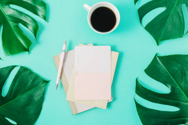 istock Summer Minimal Background Cup Coffee Blank Notebook Green Monstera Leaves 1128832475