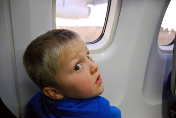 istock A child looks to camera on an airplane 1128832712