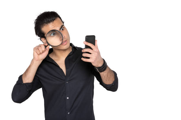 man looks carefully at the mobile phone