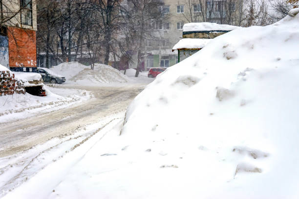 istock Snow-covered city street during a winter snowfall 1128838207