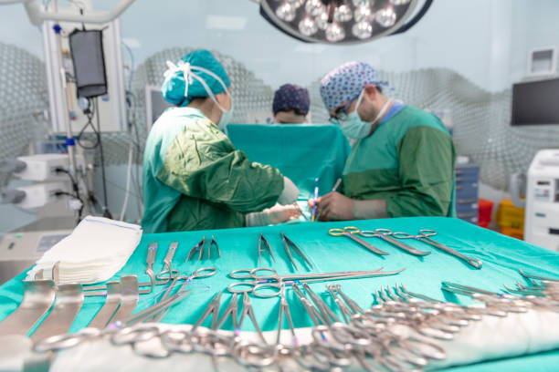 istock Surgeons in full surgical gear during operation 1128838756