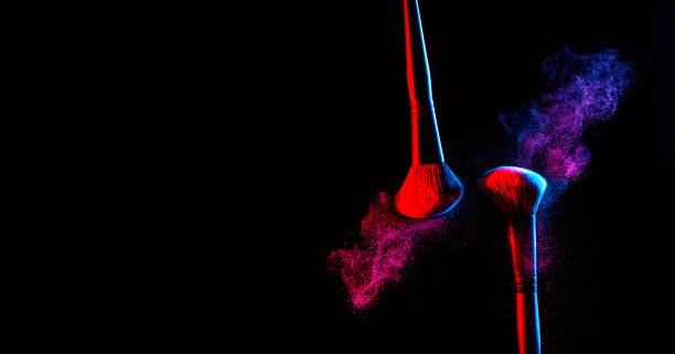 make up cosmetic brushes with powder blush explosion on black background. free space for your text. skin care or fashion concept. nice red and blue neon lighting - face powder exploding make up dust imagens e fotografias de stock