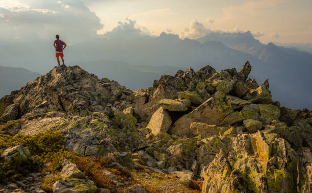 istock Hiker on top of mountain at sunset 1128842614