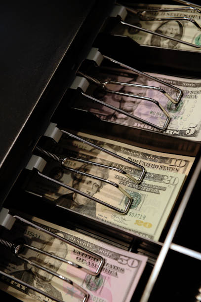 istock High angle view of cashier searching 1128842860