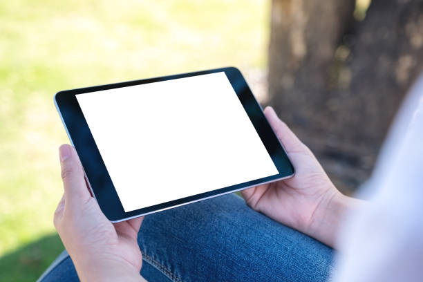 istock a woman holding and using black tablet pc with blank white desktop screen 1128843781