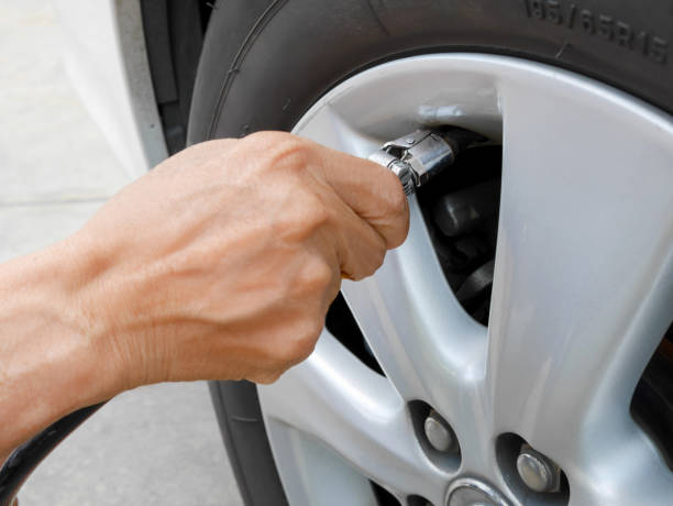 istock Hand holding tire inflator 1128843952