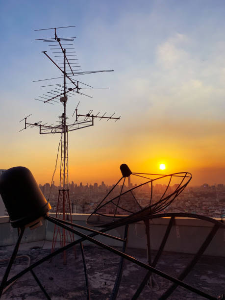 istock Televisions antennas with twilight sky in the city scape background. 1128845372